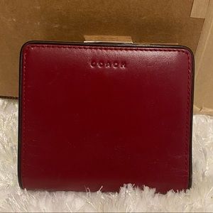 Red coach wallet with coin section.